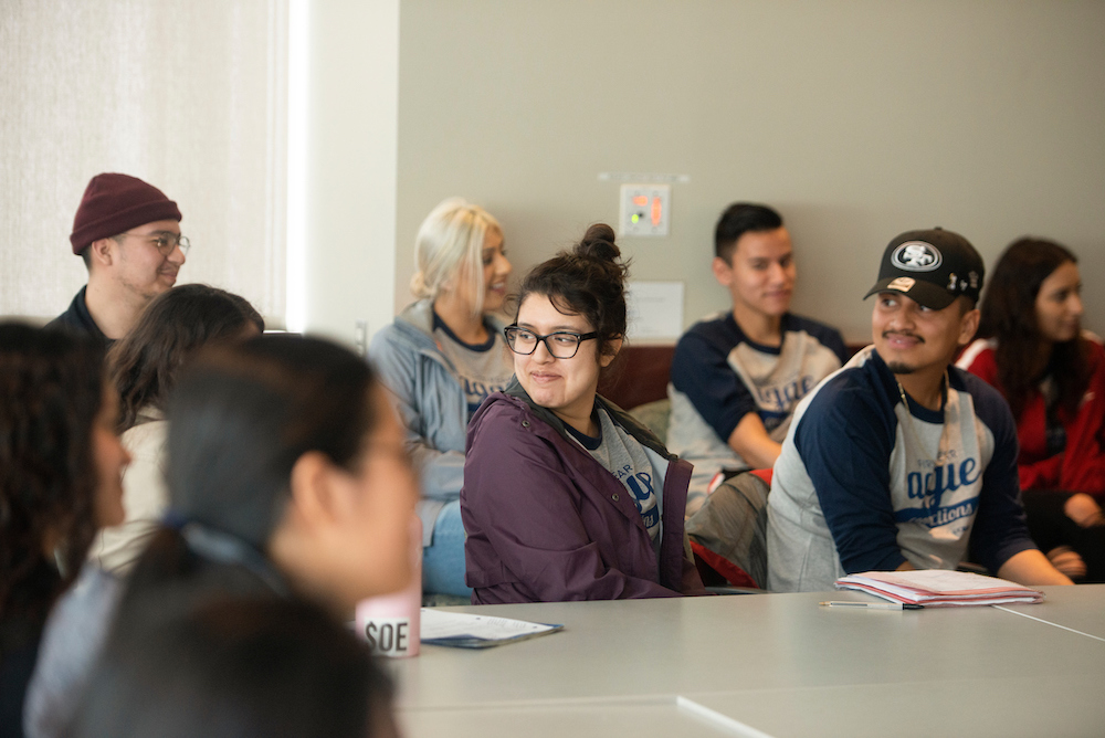 Students in a meeting smile together at UC Davis.