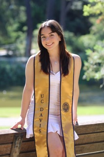 Leah poses with her graduation sash at UC Davis.