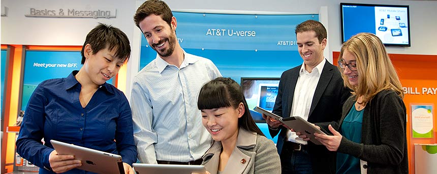 five students collaborating on an MBA research project in a classroom