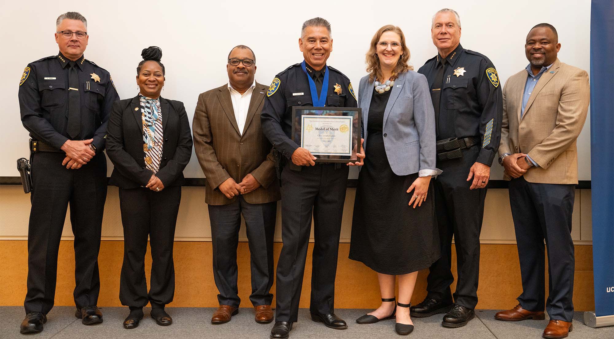 Police Chief Joe Farrow poses for photo with several other people