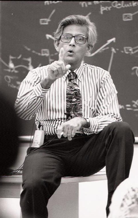 Ayima Mukherjee, sitting on desk, teaching