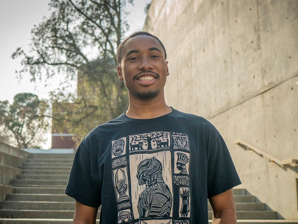 A portrait of Nate Walker standing on one of the many staircases at the Social Sciences Building on the UC Davis campus