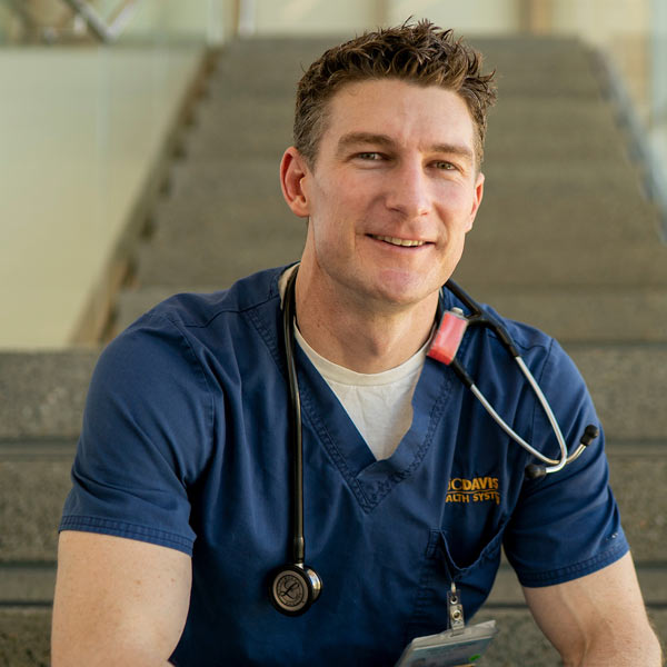 A male nursing student poses for a quick photo in the Betty Irene Nursing school at UC Davis