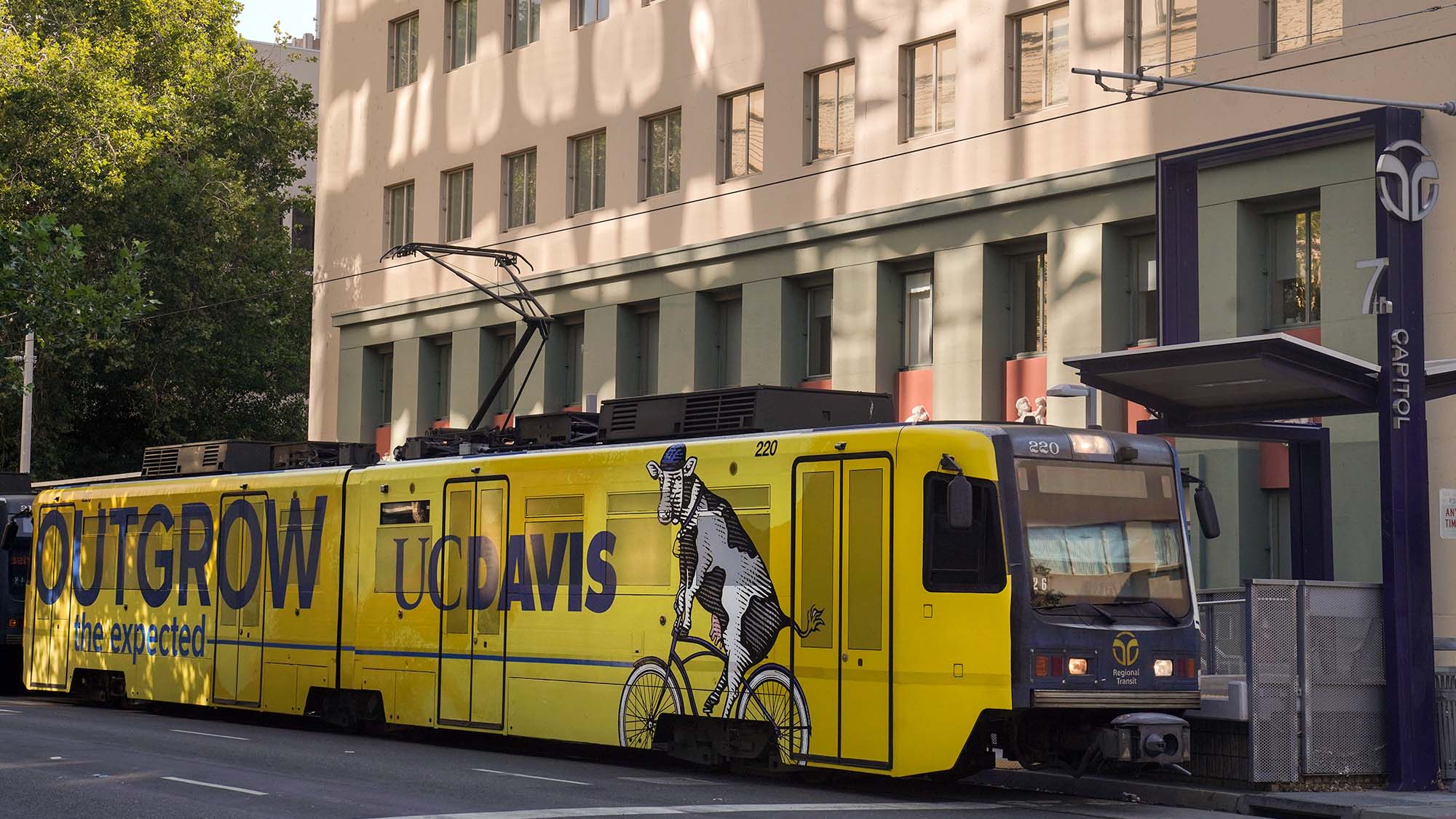 Sacramento Regional Transit light rail train with wrap: Outgrow the Expected, UC Davis