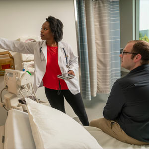 A doctor shows a patient test results