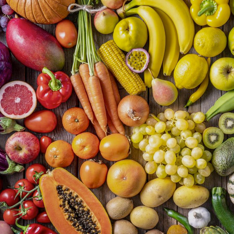 A table top covered by fruits and vegetables