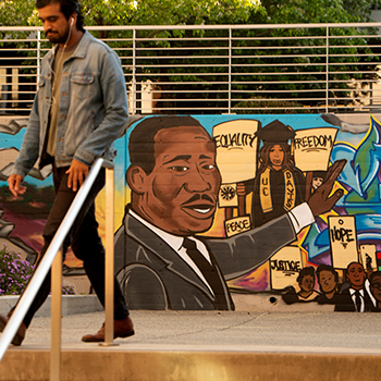 law student walks through courtyard at uc davis school of law