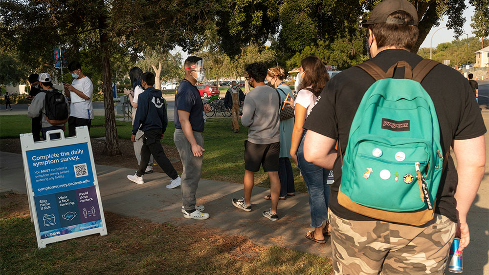 Outside, staff and students move through a line for asymptomatic COVID-19 testing at the ARC