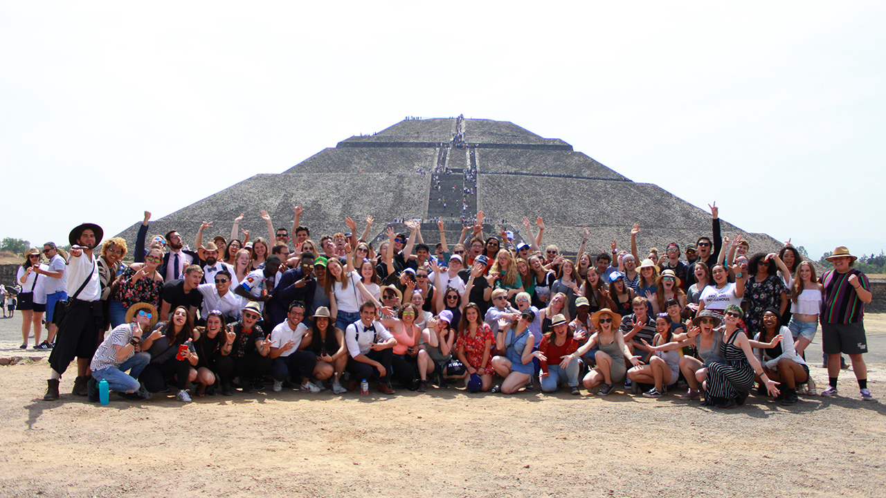 A group of students poses in front of a pyramid in Mexico City on UC Davis study abroad.