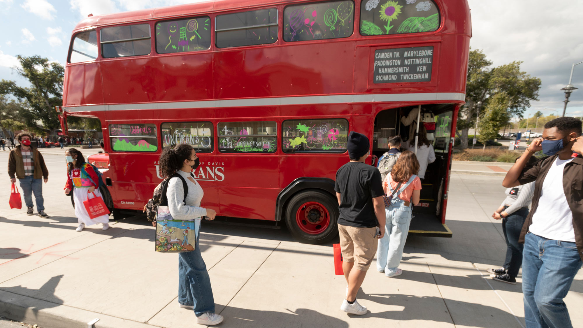 People board vintage double-decker bus