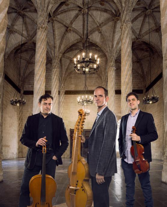 Musicians in black jackets with instruments on a stage