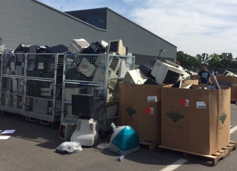 Cagelike containers and boxes, filled with e-waste