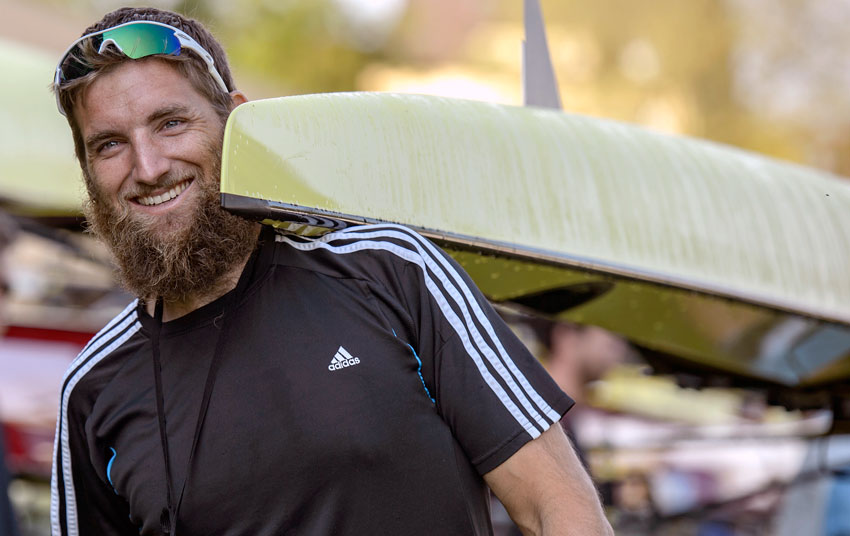 Seth Weil with boat on shoulder