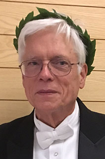 Professor Philip Shaver in white tie, with real laurel on his head.
