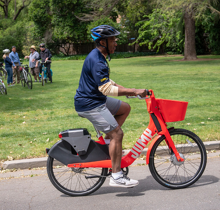 Chancellor Gary S. May rides a JUMP Bike.