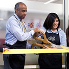 Gary S. May and Annie Adachi cut the ribbon on the Pantry's new location.