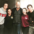 Students and others pose for a photo with Stephen McFeely