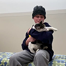 A boy holds a cat