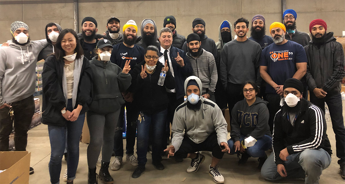 Students pose for a photo inside a warehouse.