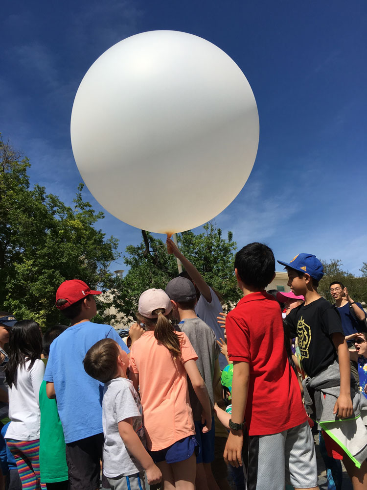 Children launch weather balloon.