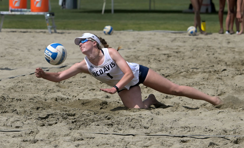 Player dives for ball in beach volleyball.