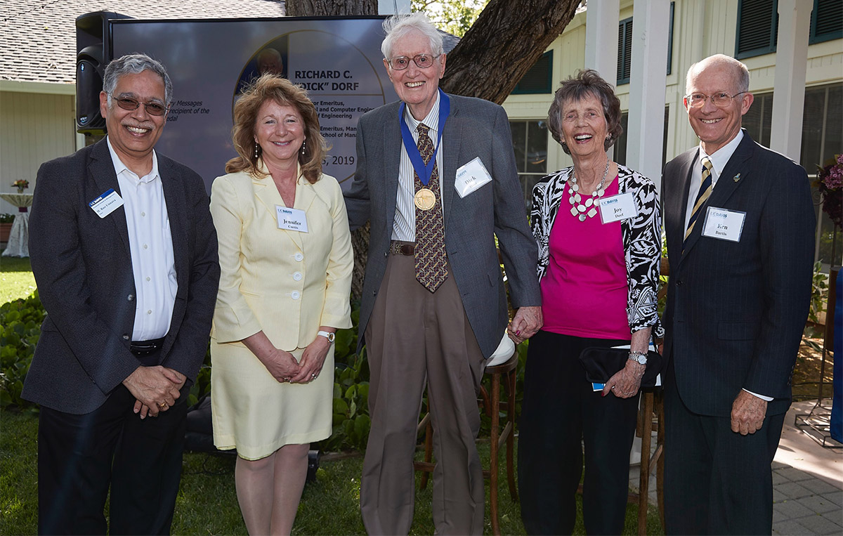 Dick Dorf poses for photo with deans and his wife.