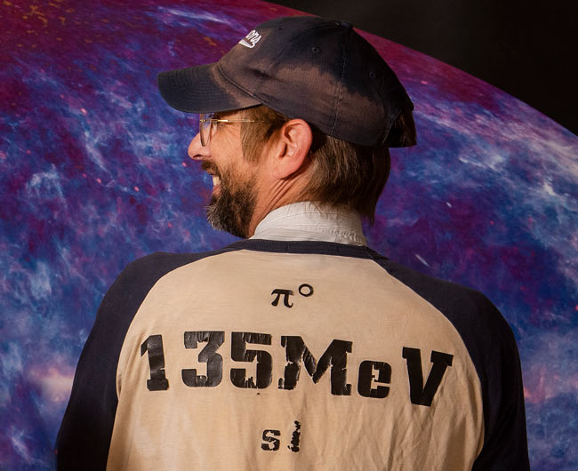 Ballplayer in jersey with physics particle descriptor on the back.