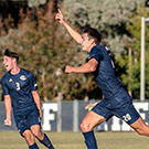 Soccer players run and celebrate.