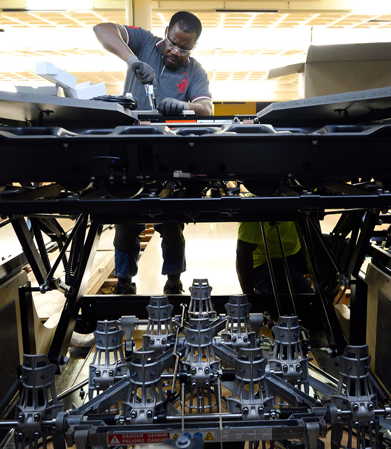 A worker installs new bowling pinsetters.