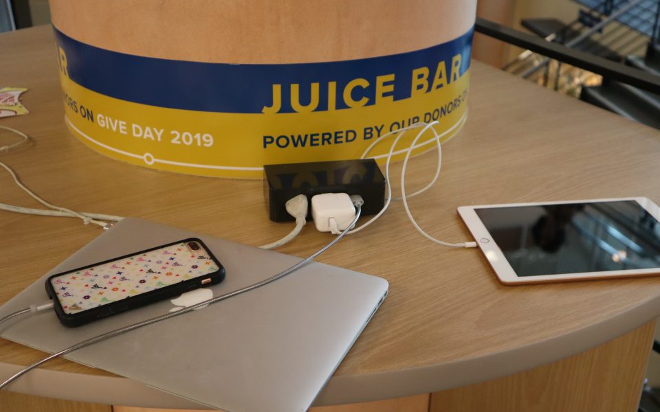 Phones charging on a table.