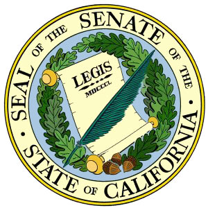 A feather pen atop a "Legis" document, encircled by a laurel wreath.