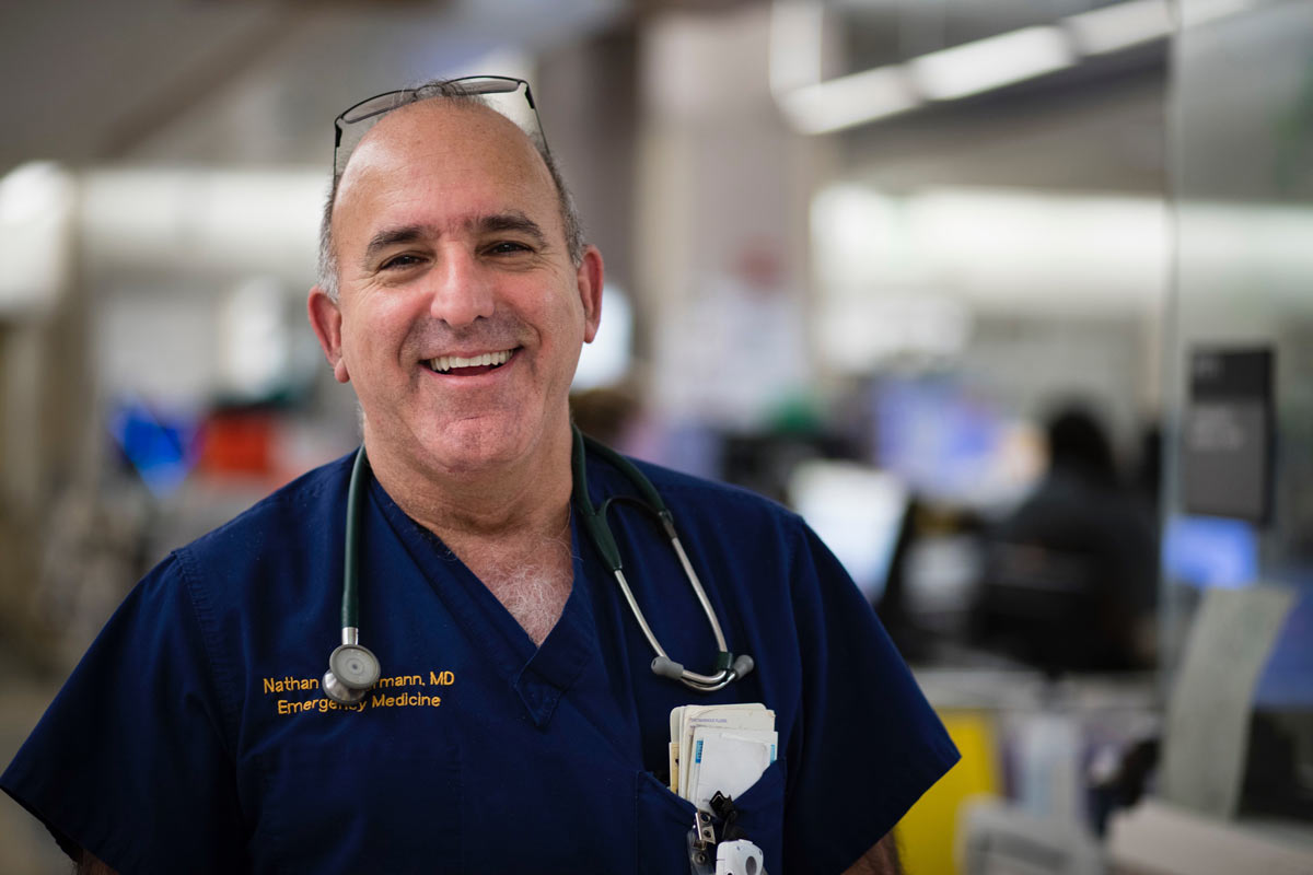 Nathan Kuppermann in scrubs, stethoscope around neck, big smile.