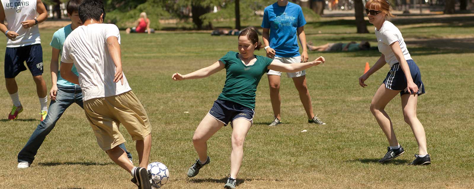 men and women play soccer