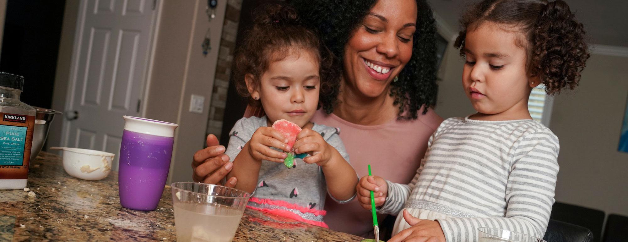 A mother and her two children play in their home