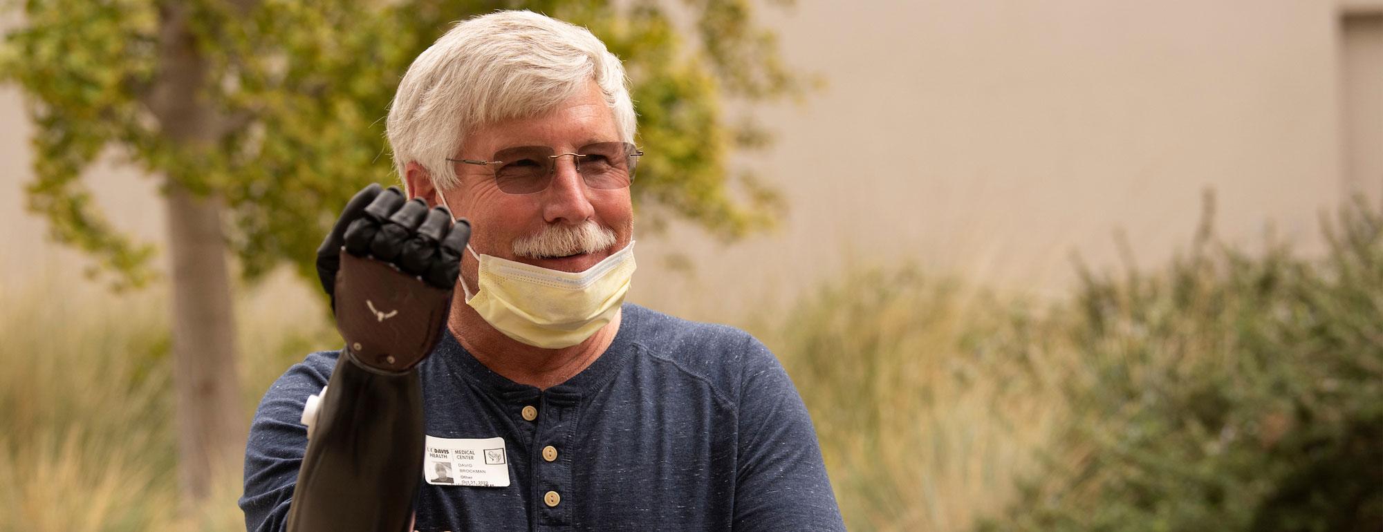 A person displaying their prosthetic robotic hand