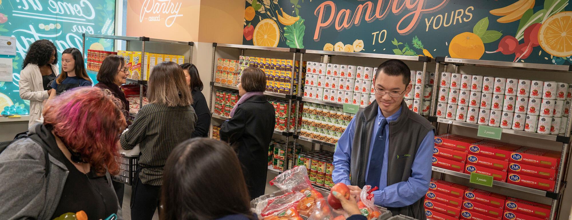 A student helps pass out complimentary food to those in need at the UC Davis food pantry
