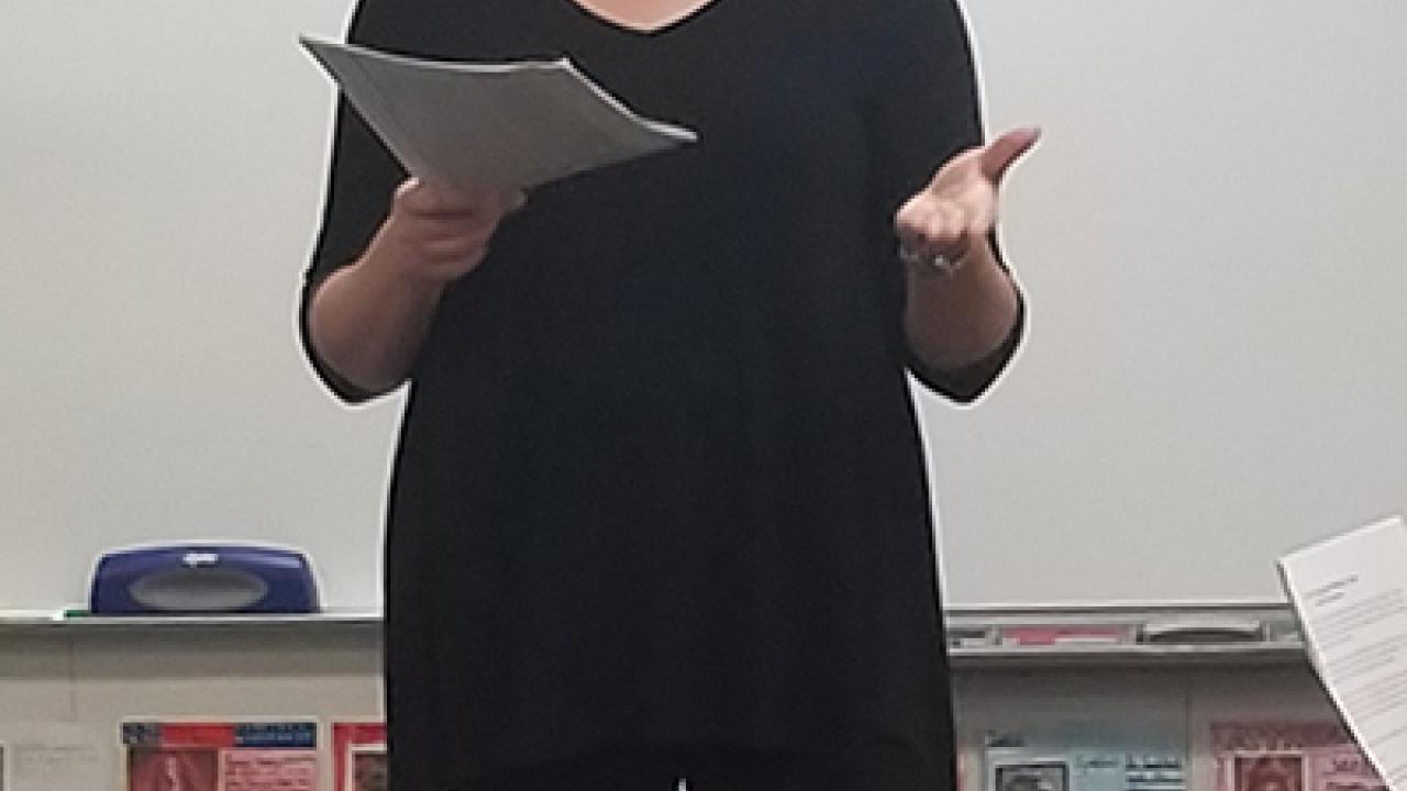Woman standing and talking in elementary classroom