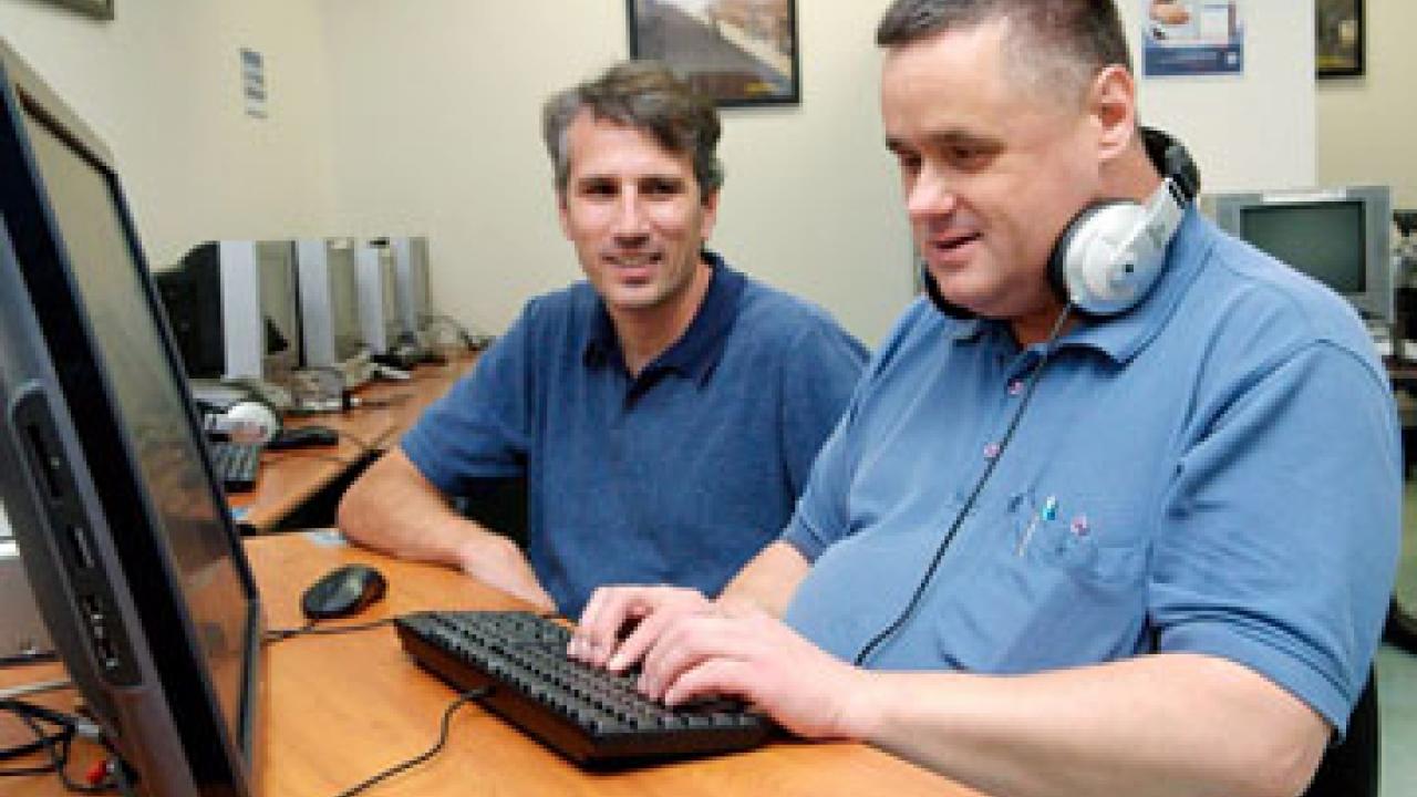 Photo: Tim Leamy, computer lab manager for Academic Technology Services, and Russ Zochowski, disability specialist at the Student Disability Center.