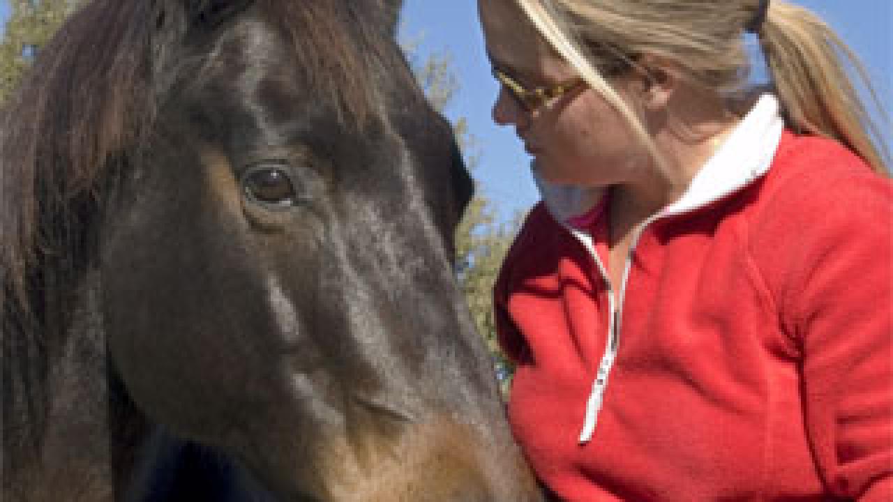 photo: woman talking to horse