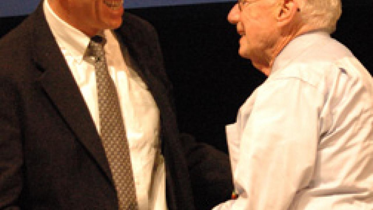 Alan Meier, a visiting scientist at the UC Davis Energy Efficiency Center, congratulates Arthur Rosenfeld during the March 9 symposium.