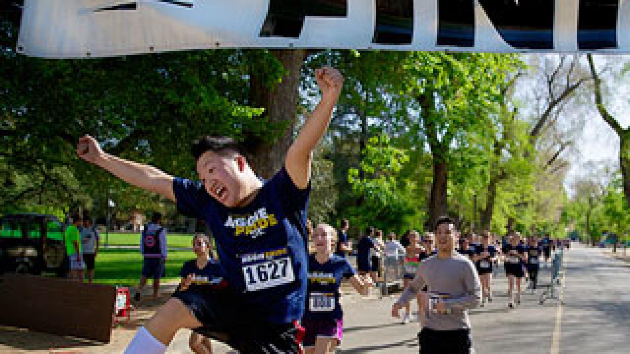 Students jumping in the air wearing Aggie T-shirts
