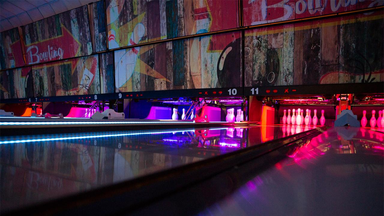 Bowling lanes with colorful lights.