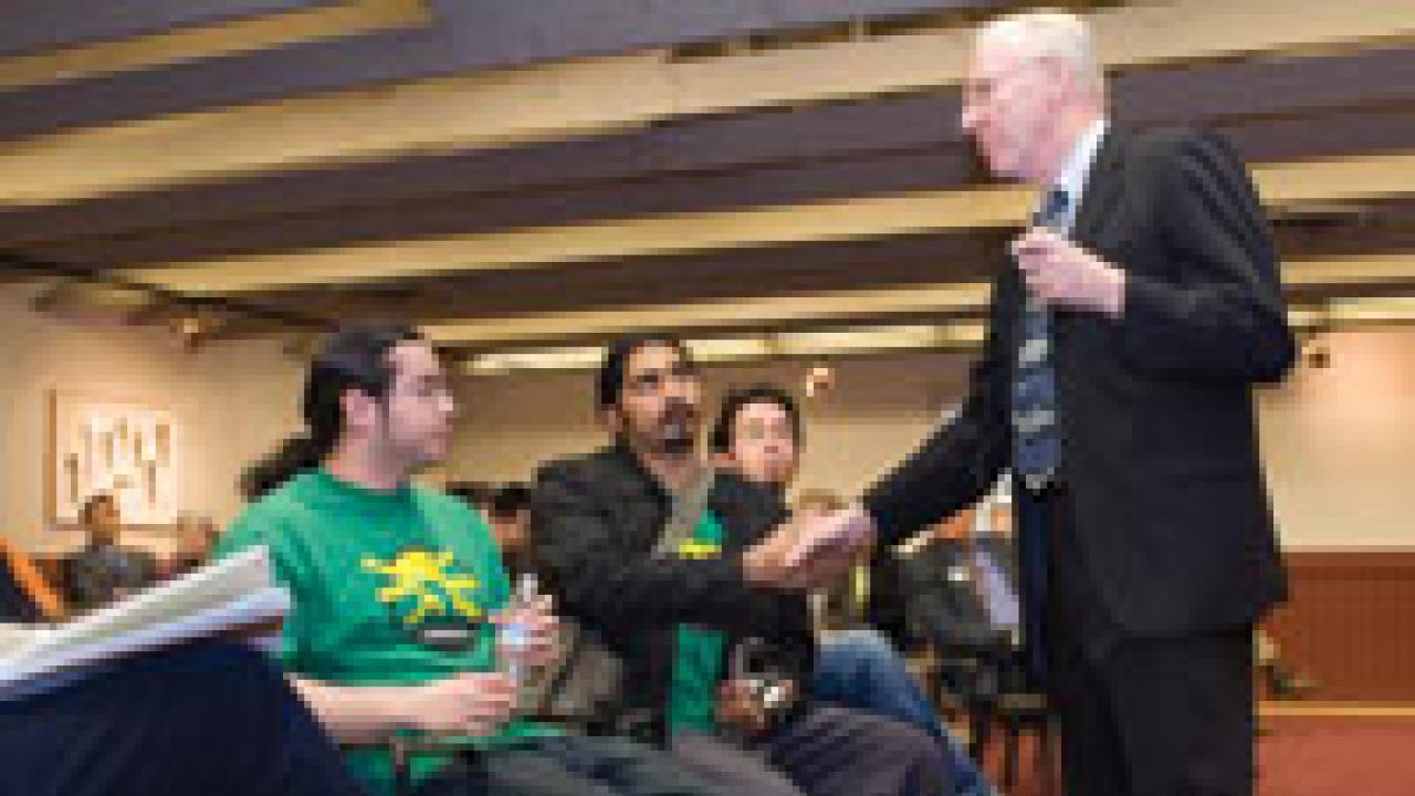 Julian Posadas, a UC Santa Cruz food service worker and vice president of the American Federation of State, County and Municipal Employees chapter 3299, shakes hands with Chancellor Larry Vanderhoef at a March 1 brown bag.
