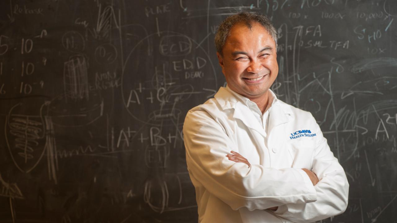 Chemist Carlito Lebrilla in front of blackboard