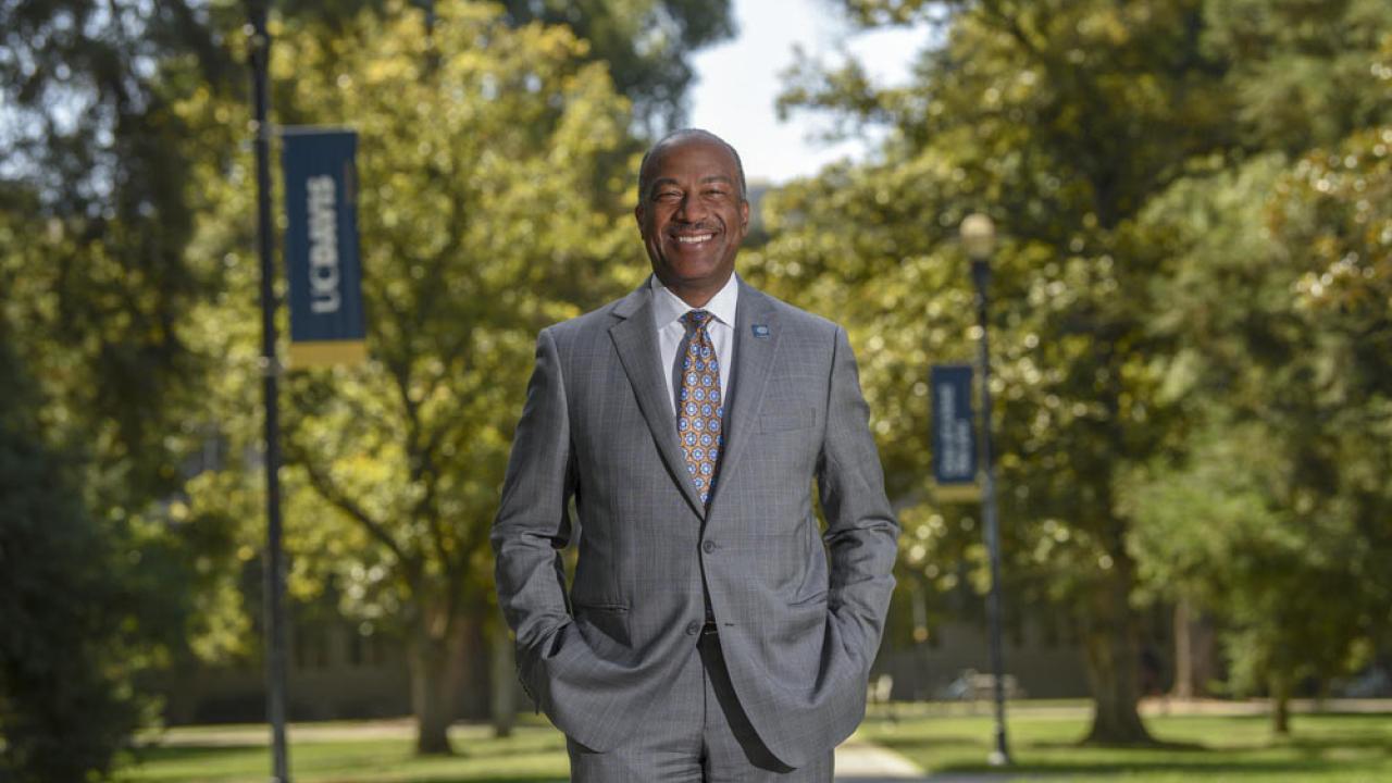 Gary S. May, smiling, posing, on the Quad.