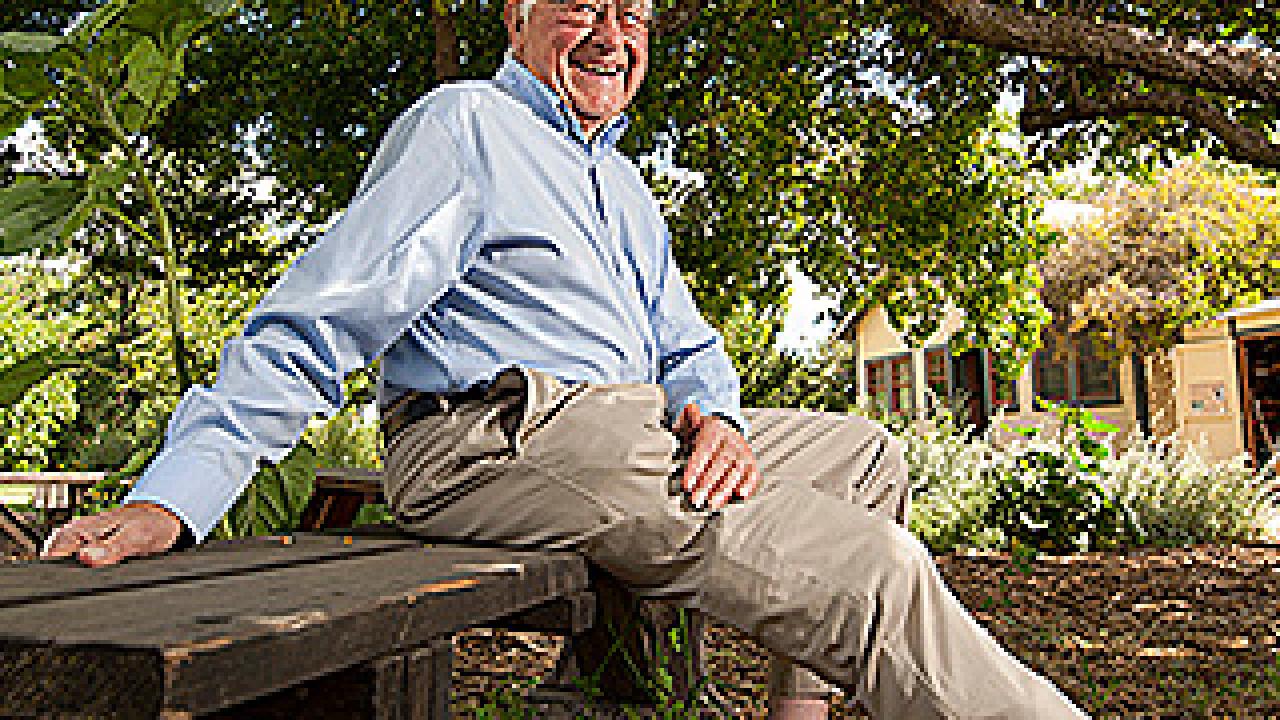 Charley Hess sitting on a bench in a garden