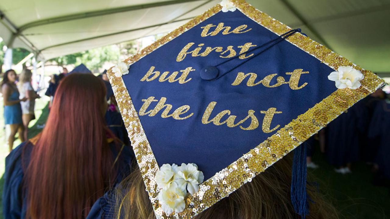 A graduation cap says "the first but not the last"