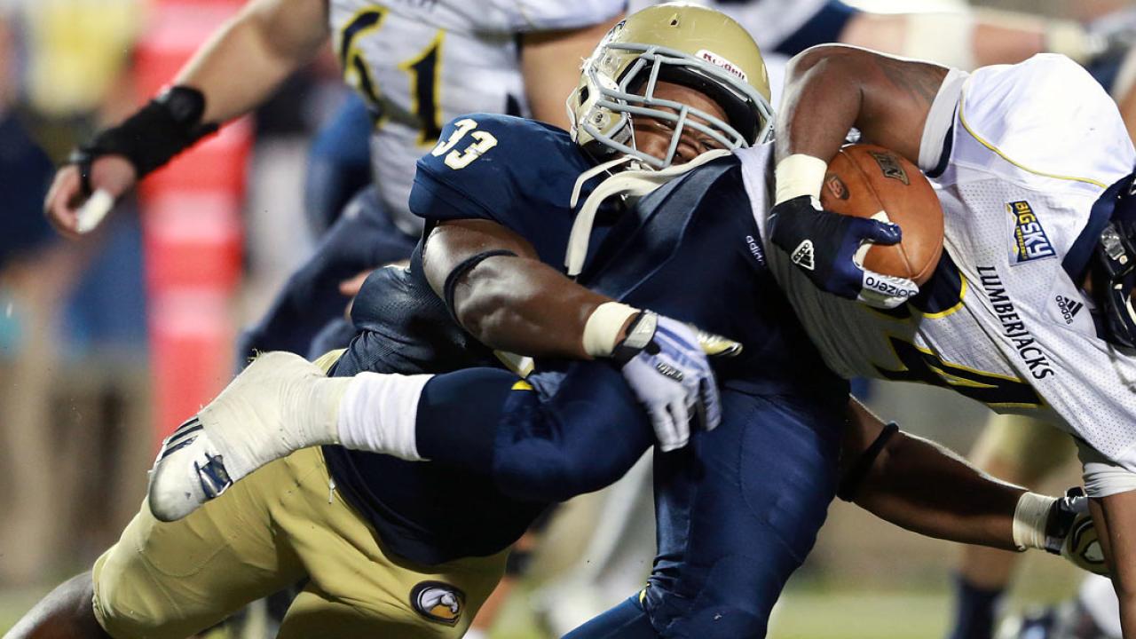 Linebacker Steven Pitts stops a Northern Arizona running back