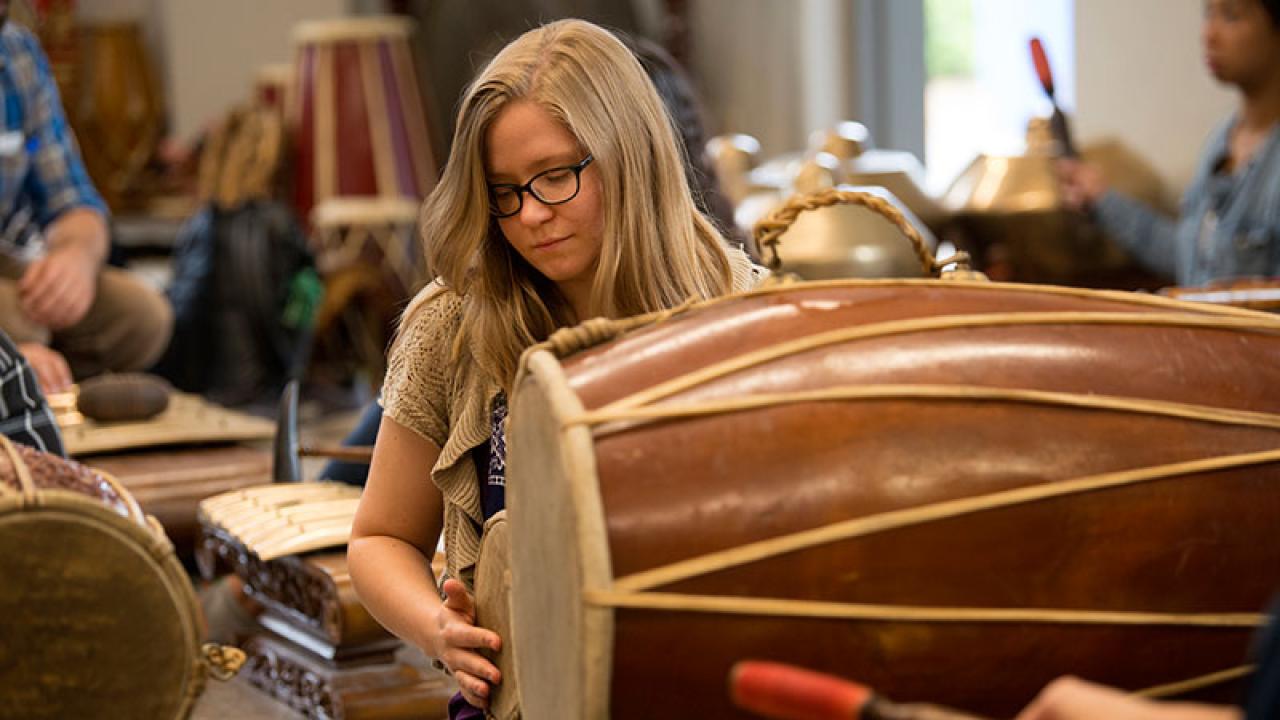 A woman plays drums