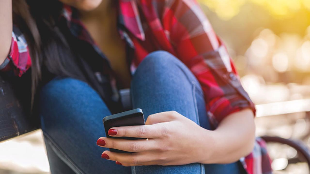 Girl seated and texting